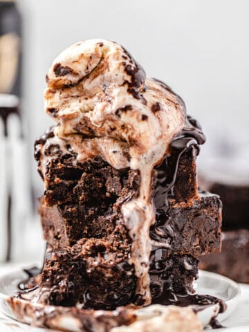 stack of brownies topped with two scoops of vanilla ice cream