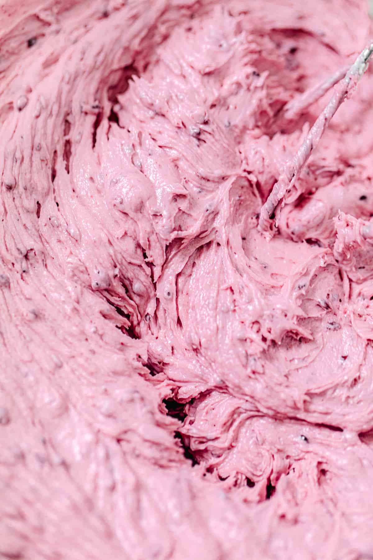 super close shot of blackberry frosting in a bowl