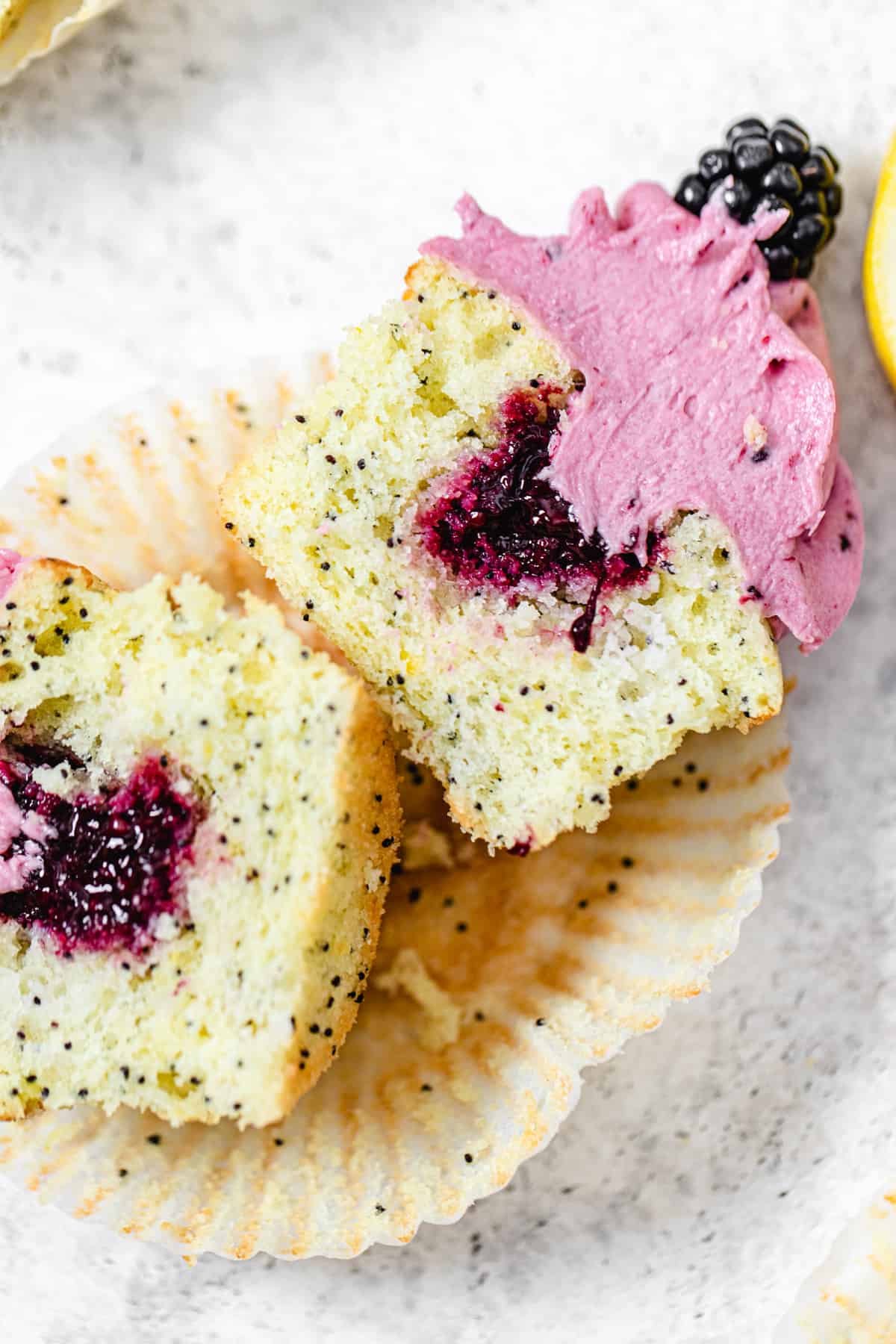 close up of halved cupcake filled with blackberry sauce