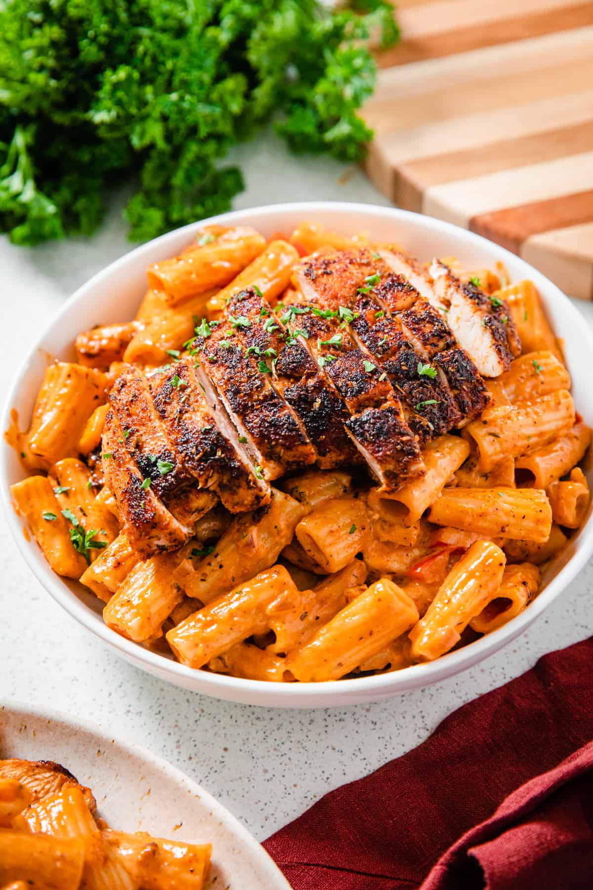 sliced chicken breast on a plate of pasta