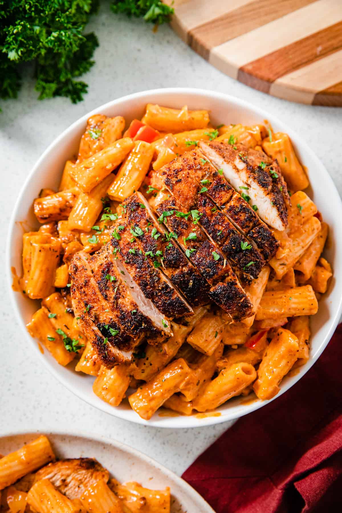 top view of a plate of creamy pasta topped with sliced chicken breasts