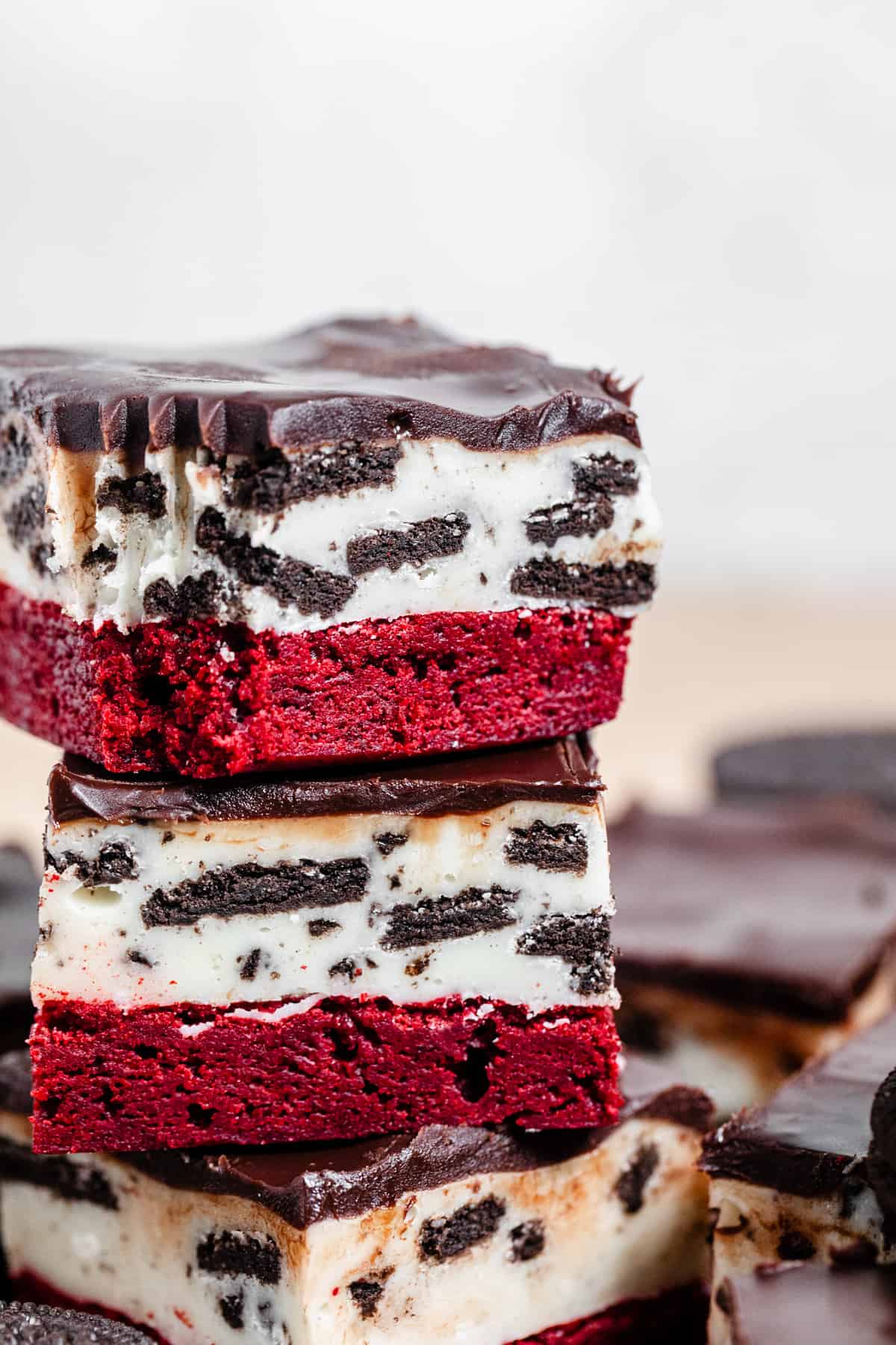 close up of red velvet brownie topped with Oreo fudge and chocolate ganache
