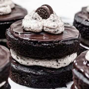 mini chocolate layer cake filled and topped with cookies and cream frosting, topped with ganache and a mini Oreo